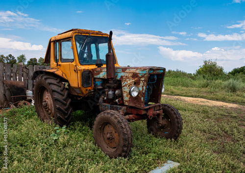 An old tractor in the countryside  Agricultural machinery. 