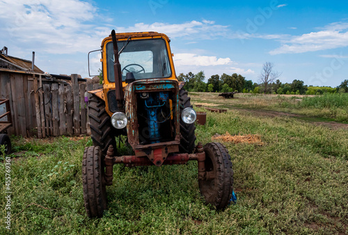 An old tractor in the countryside  Agricultural machinery. 