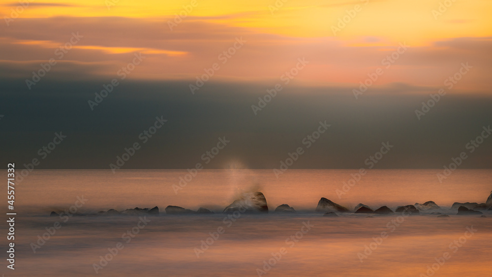 sunset sea rocks long exposure