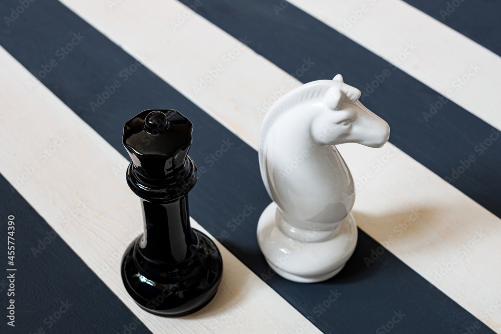 Fototapeta premium chess pieces on a striped black-white board. different rules