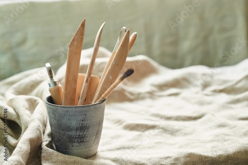 wooden tools for working with clay and ceramics on a linen background in a ceramic glass