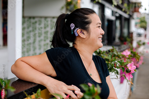 Happy woman with cochlear implant outdoors photo