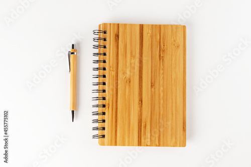 bamboo notebook and pen on a white background photo