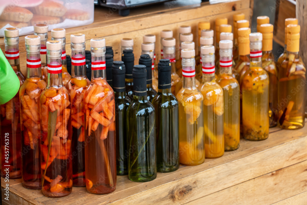 Bottles of artisan liquor, macerated with various fruits. Bottles of