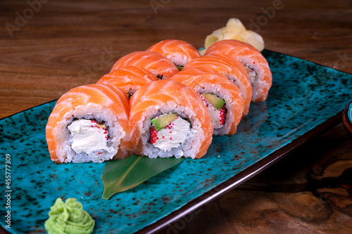 Sushi set with red fish on the table on blue dishes