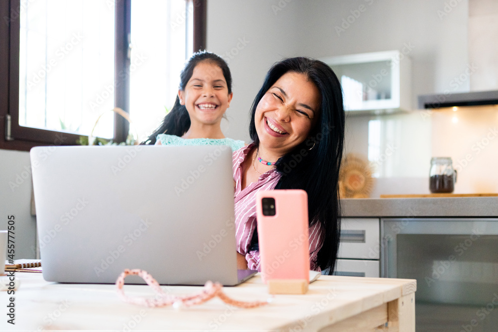 Mother and daughter at home looking at camera Mother and daughter at home looking at camera