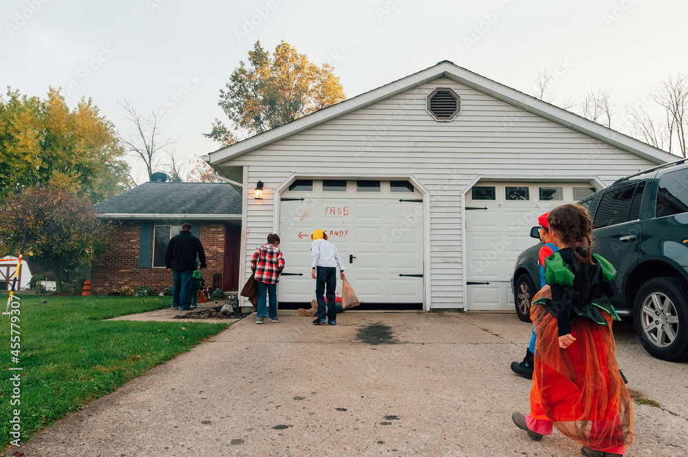 Children walking up to a decorated house for Halloween. Children walking up to a decorated house for Halloween.