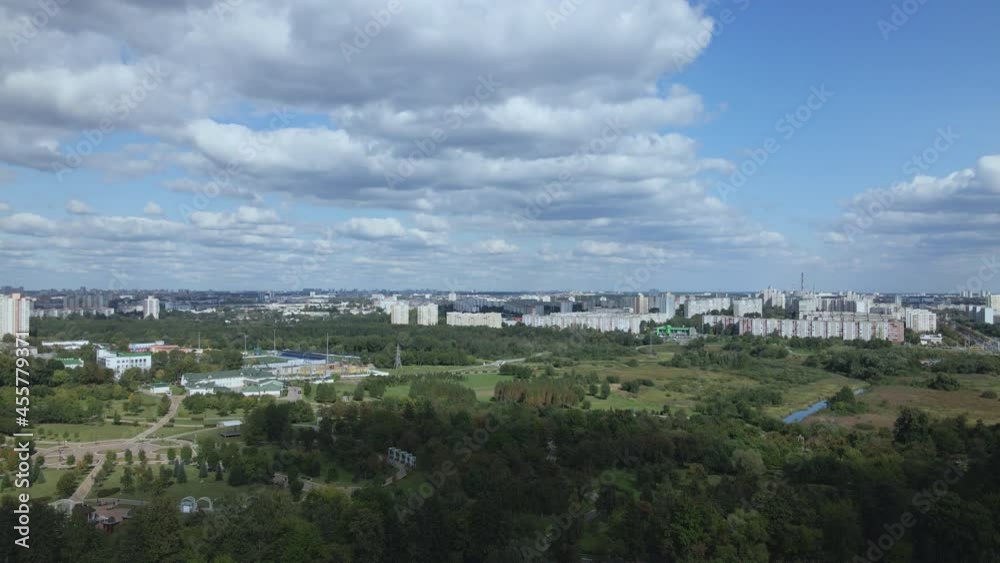 City landscape. Nearby there is a park area. Blue sky with white clouds. Aerial photography. City landscape. Nearby there is a park area. Blue sky with white clouds. Aerial photography.