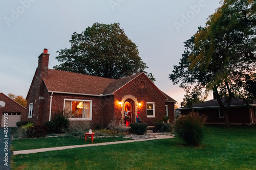 Trick or treaters leaving a house.  photo