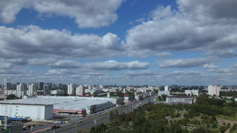 City landscape. Nearby there is a park area. Blue sky with white clouds. Aerial photography. City landscape. Nearby there is a park area. Blue sky with white clouds. Aerial photography.