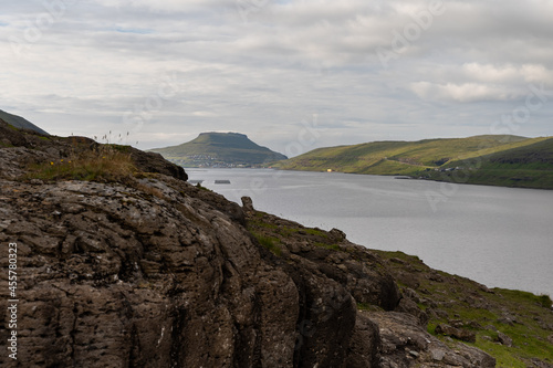 Beautiful view of the Cains - rock stacking in fort of the ocean bay in the Faroe Islands