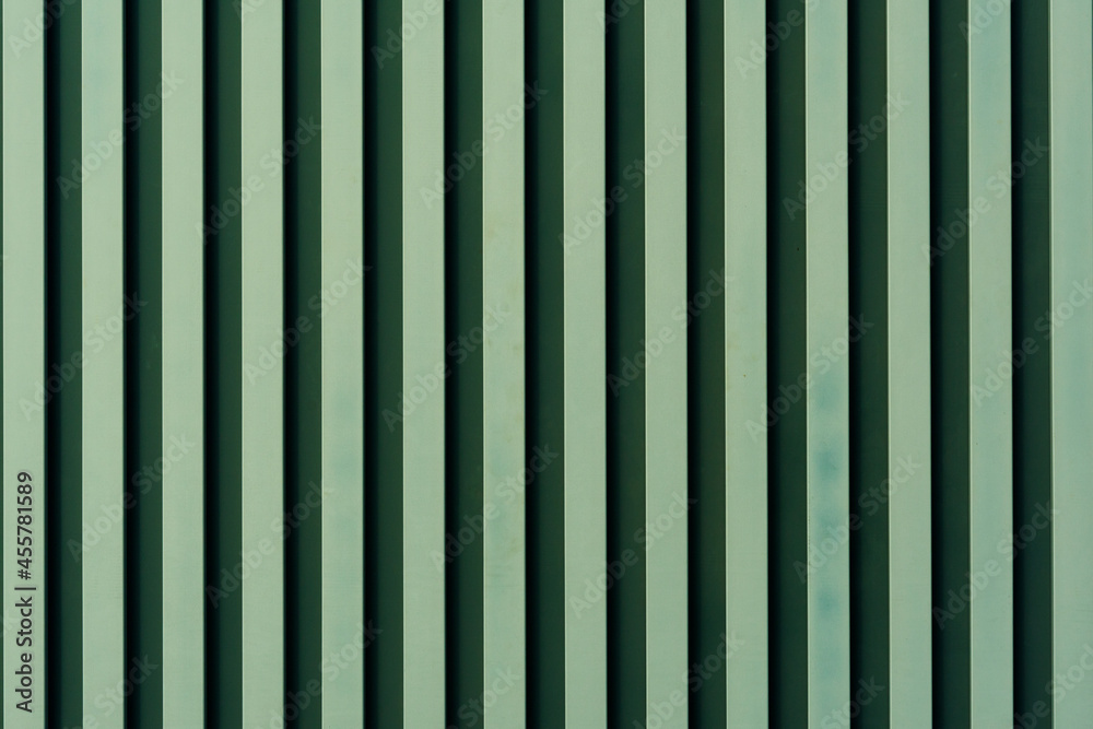 streams on a light surface. A background with strips from green color. vertical streams of green paint. Background abstract structure streams on a light surface. A background with strips from green color. vertical streams of green paint. Background abstract structure