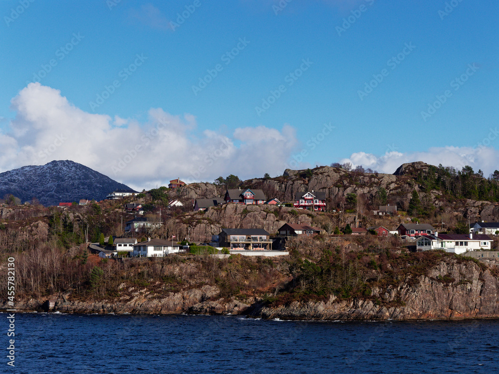 A mix of Traditional and modern Norwegian Houses on a rocky Headland in the Fjord close to the City of Bergen.