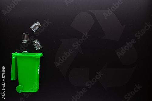 Trash glass recycle. Bin container for disposal garbage waste and save environment. Green dustbin for recycle glass can trash on black background. Top view.