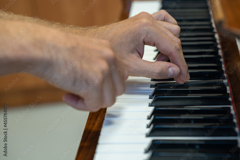 Play the piano. Hands on the piano keyboard.