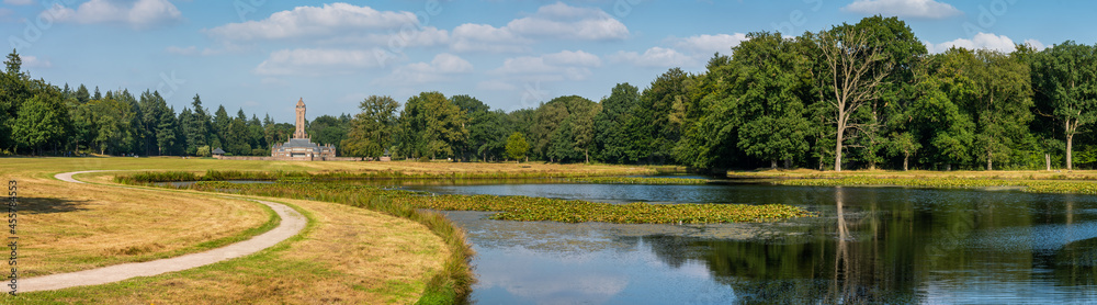 Panorama of dutch national park De Hoge Veluwe with lake and the building of hunting lodge Sint Hubertus
