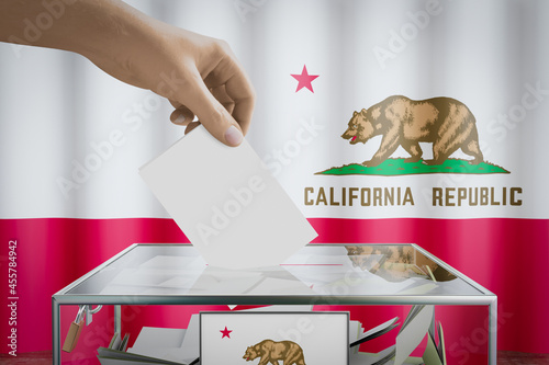 California flag, hand dropping ballot card into a box - voting, election concept - 3D illustration photo