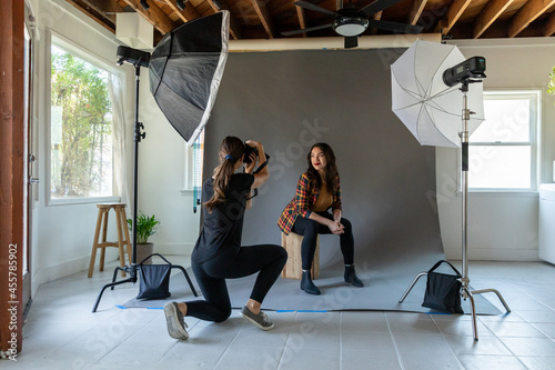 Woman Shoots Model in a Studio photo