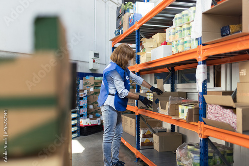 Volunteer woman preparing food packages