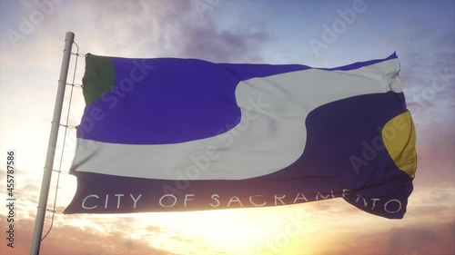 Sacramento city flag waving in the wind, sky and sun background photo