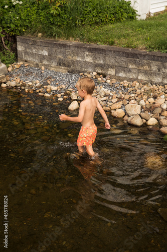 Little boy walking in water