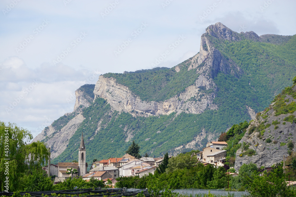 view of village in the mountains and orchards southern france