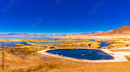 Tourists enjoying the Aguas Termales de Polques Hot Springs at dawn, Salar de Uyuni, Bolivia
