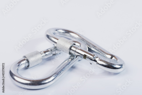 Metal snap hooks on a white isolated background.Spring carabiner made of stainless steel, heavy duty carabiner with quick release lock. 