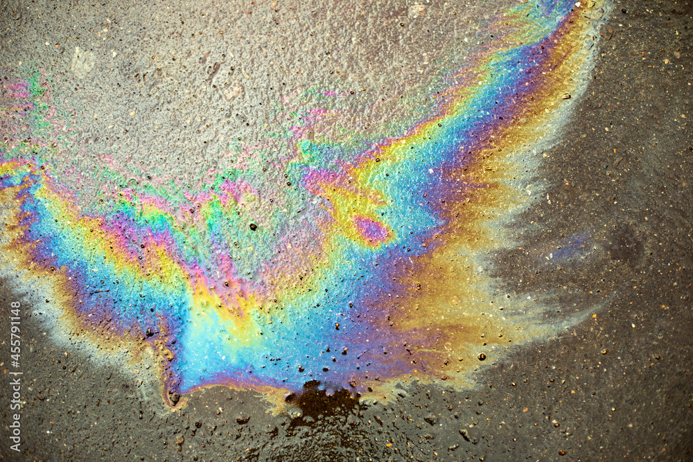Gasoline stain on the asphalt. Fuel texture. Rainbow spot of ...