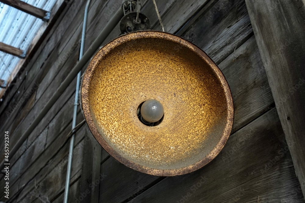 Old rusty light fixture on wooden structure Old rusty light fixture on wooden structure