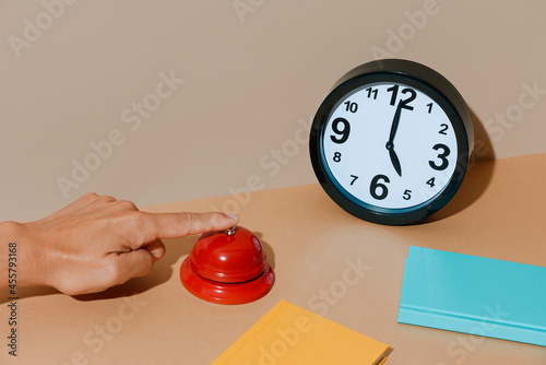 man rings a red call bell at five