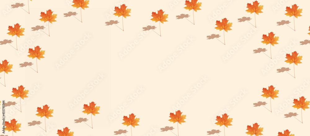 Pattern autumn maple leaf orange-red on orange background in banner format with copy space Pattern autumn maple leaf orange-red on orange background in banner format with copy space