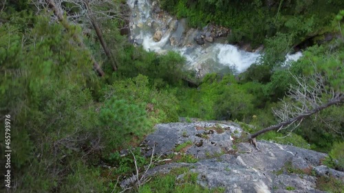 stream in a narrow mountain gorge surrounded by trees and rocks
