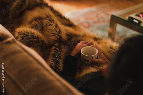 Man relaxing on couch with coffee in hand