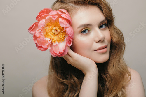 Young woman with flower in hair
 photo