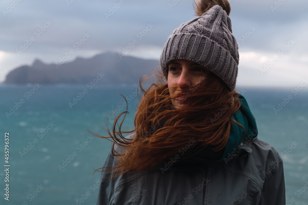 Smiling female standing on cliff near sea Smiling female standing on cliff near sea