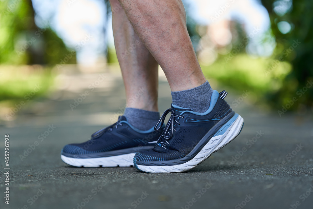 Muscular calves and shoes of a runner