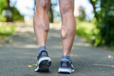 Muscular calves and shoes of a runner