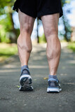 Muscular calves and shoes of a runner