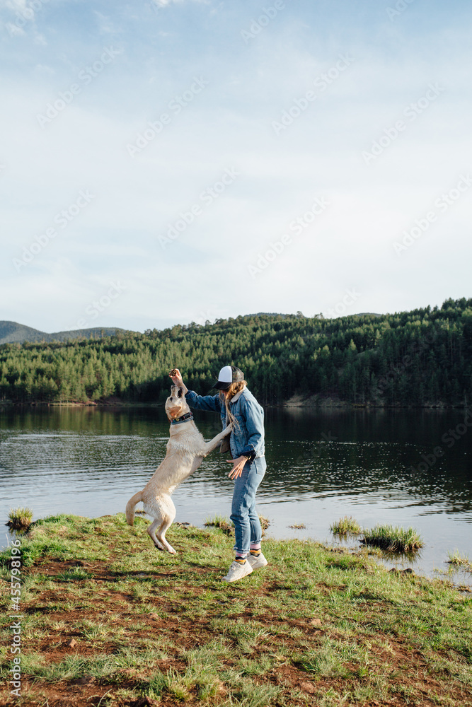 Woman Playing With Her Dog On A Lake Woman Playing With Her Dog On A Lake