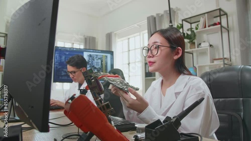 Wallpaper Mural Modern Electronics Research And Development Facility: Beautiful Asian Female Engineer Inspects Printed Circuit Board Motherboard. Scientist Designs Industrial Pcb, Silicon Microchips, Semiconductors
 Torontodigital.ca