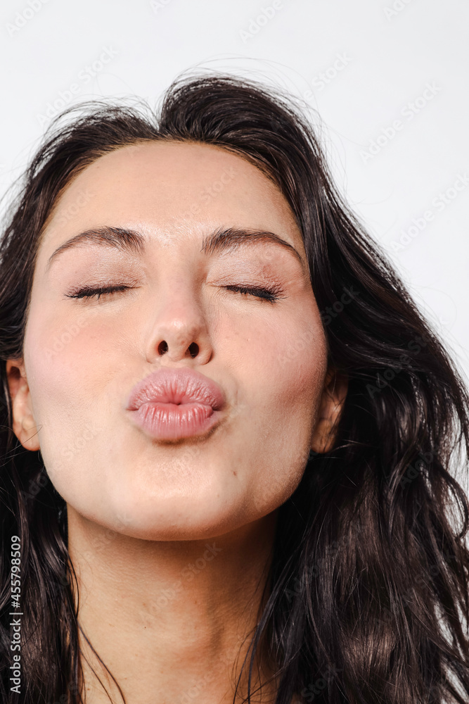 Beautiful young model with natural makeup kissing camera Stock Photo ...