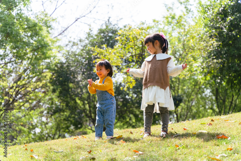 two asian baby girl playing bubble in the park two asian baby girl playing bubble in the park