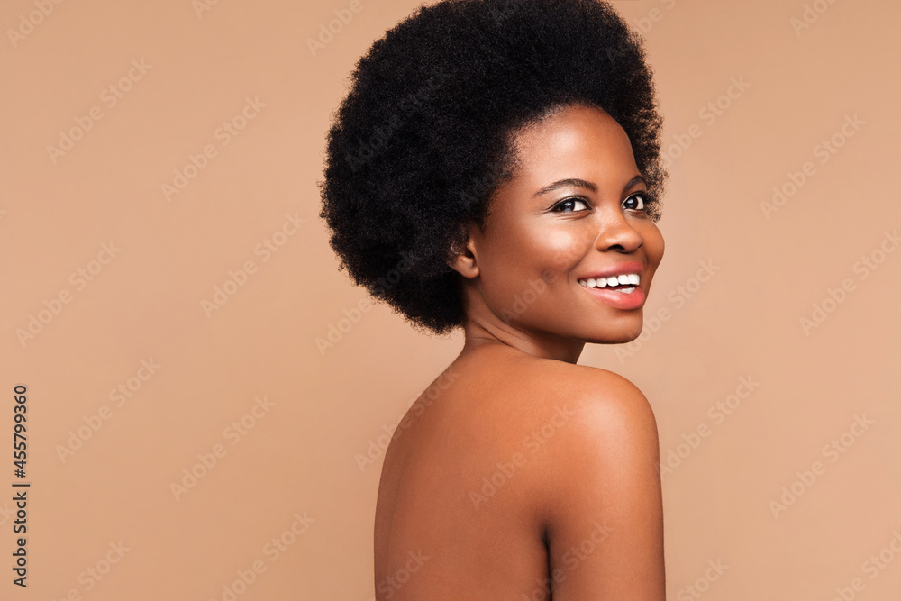 Cosmetics and cosmetology: young black girl with curly hairstyle, white smile, clean skin and makeup perfect for african skin type over beige background. Beauty salon skincare and treatment concept Cosmetics and cosmetology: young black girl with curly hairstyle, white smile, clean skin and makeup perfect for african skin type over beige background. Beauty salon skincare and treatment concept