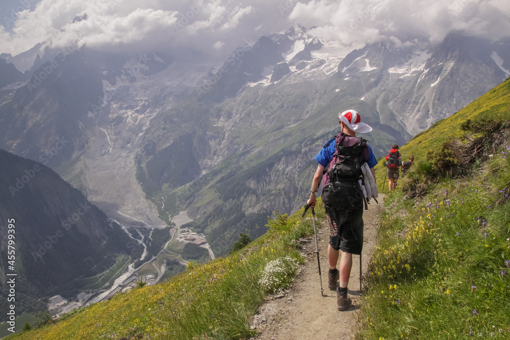 Tourists walking in the mountains, Alps rucksack, cloudy weather, trekking, Tour du mont Blanc