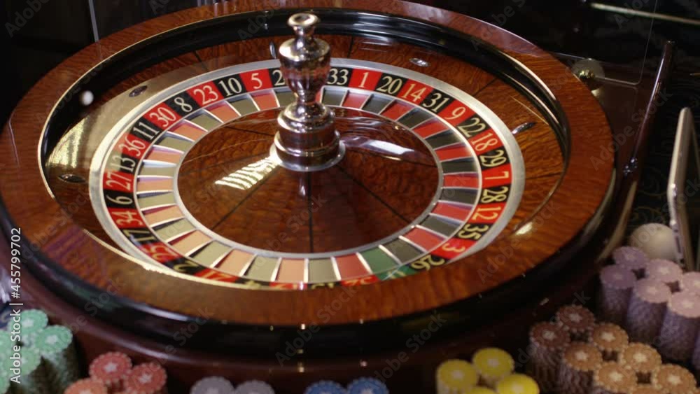Close up shot of Casino roulette in motion . Spinning wheel ball . Gambling and casino concept with playing chips . Shot on RED EPIC DRAGON Cinema Camera in slow motion with camera move Close up shot of Casino roulette in motion . Spinning wheel ball . Gambling and casino concept with playing chips . Shot on RED EPIC DRAGON Cinema Camera in slow motion with camera move