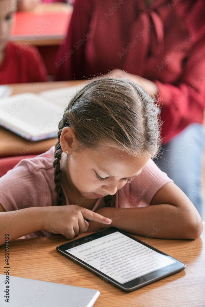 School: Girl Reading School Book On Digital Tablet School: Girl Reading School Book On Digital Tablet