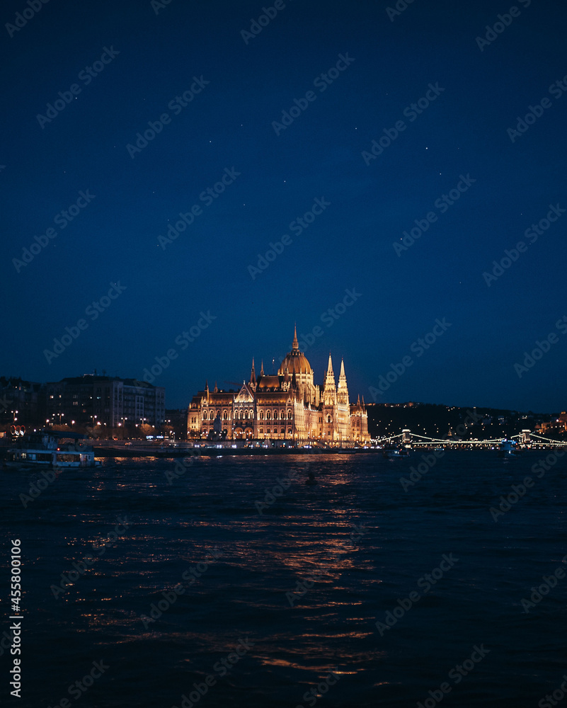 beautiful view from the water on the educated parliament building in night Budapest, side view general plan