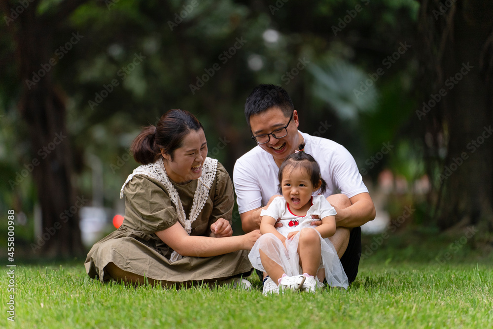 happy asian family with baby in the park happy asian family with baby in the park