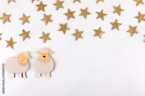 Feast of the Sacrif. Greeting card with wool lambs figures against a white background. Eid al-Adha Mubarak.Traditional Muslim holiday concept. Copy space. photo